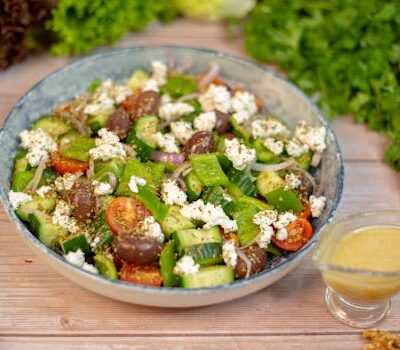 A vibrant Greek salad with fresh vegetables, feta cheese, and olives, perfect for a healthy meal.